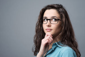Beautiful Girl with Glasses Holding Her Chin
