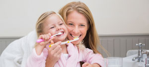Mother and Daughter Brushing Teeth - Rochester, MN - Apollo Dental Center